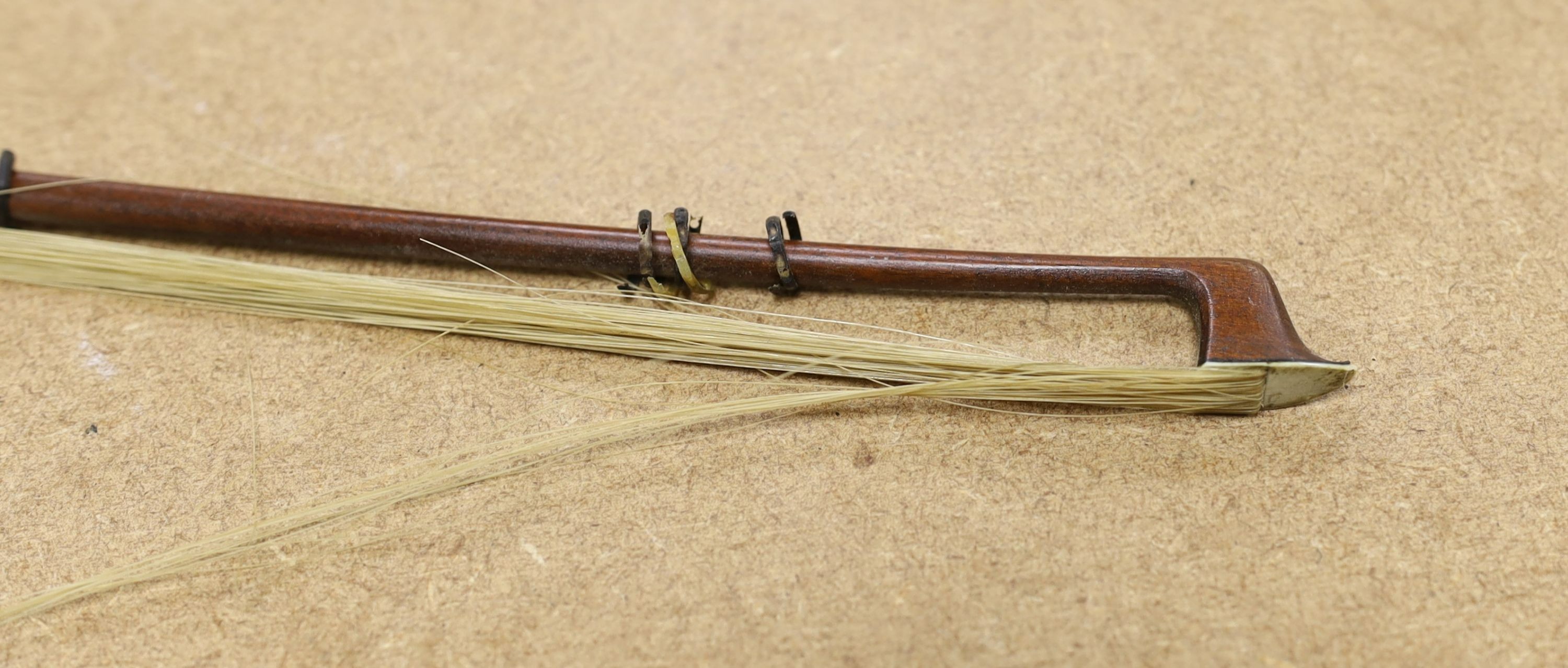 A 19th century violin with 14 inch 2 piece back, unlabelled, cased with silver mounted bow.